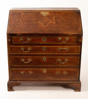 A George III oak bureau fitted