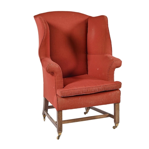 A George III wing back armchair, on