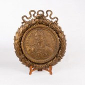 A gilded decorative plaque of