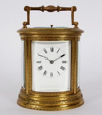 A gilt brass carriage clock in an