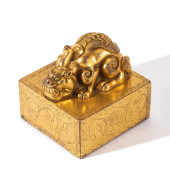 A GILT BRONZE BEAST SEAL<br>A