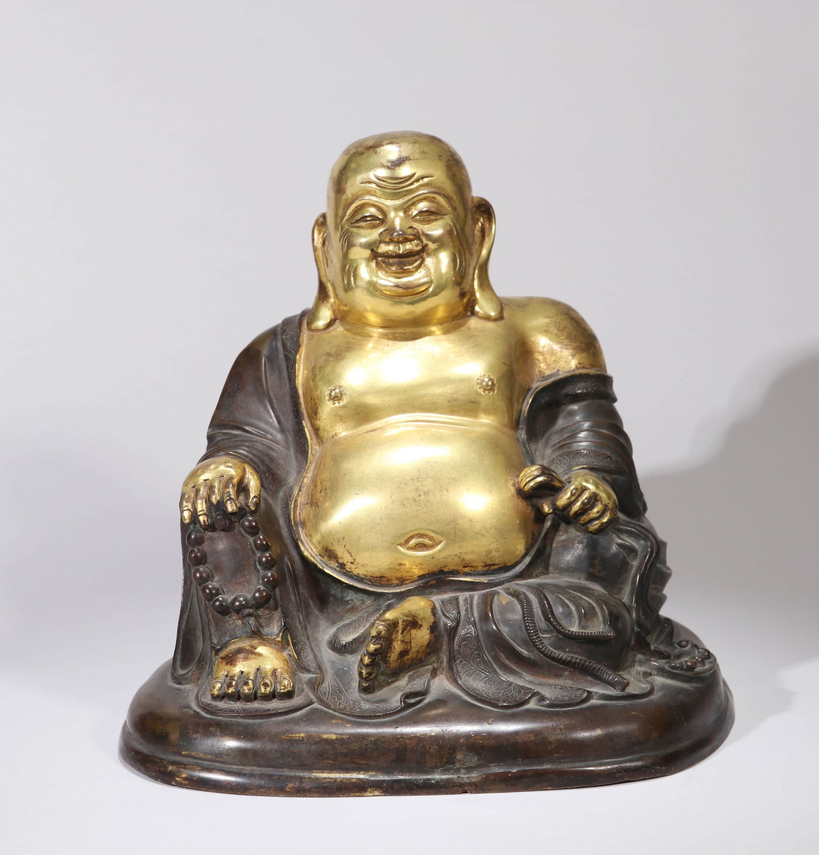 A GILT-BRONZE BUDAI FIGUREA