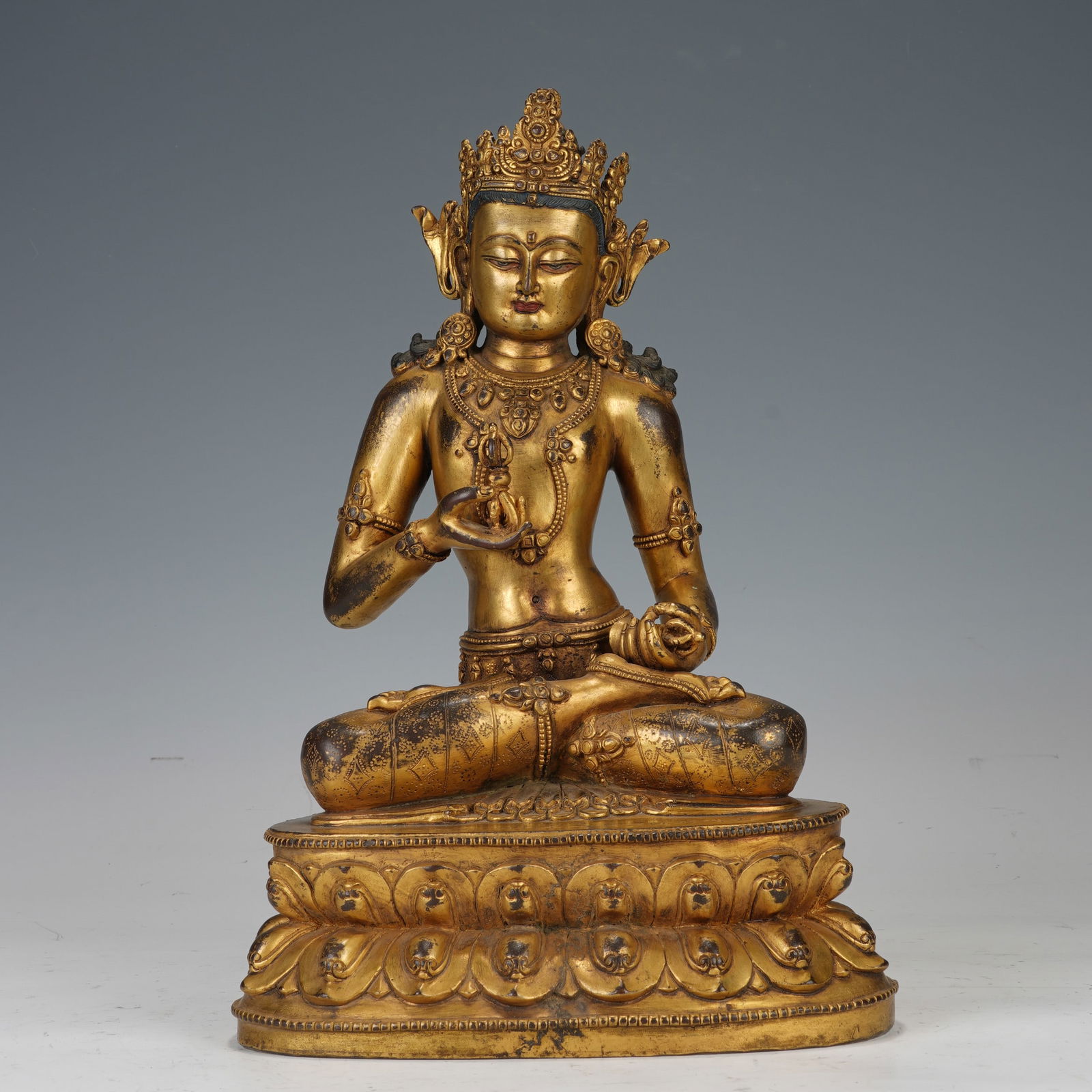 A GILT - BRONZE BUDDHIST