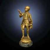 A GILT BRONZE FIGURE OF A YOUN