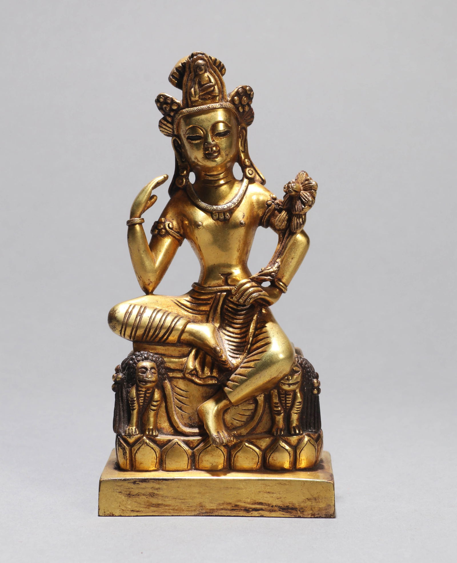 A GILT-BRONZE FIGURE OF A