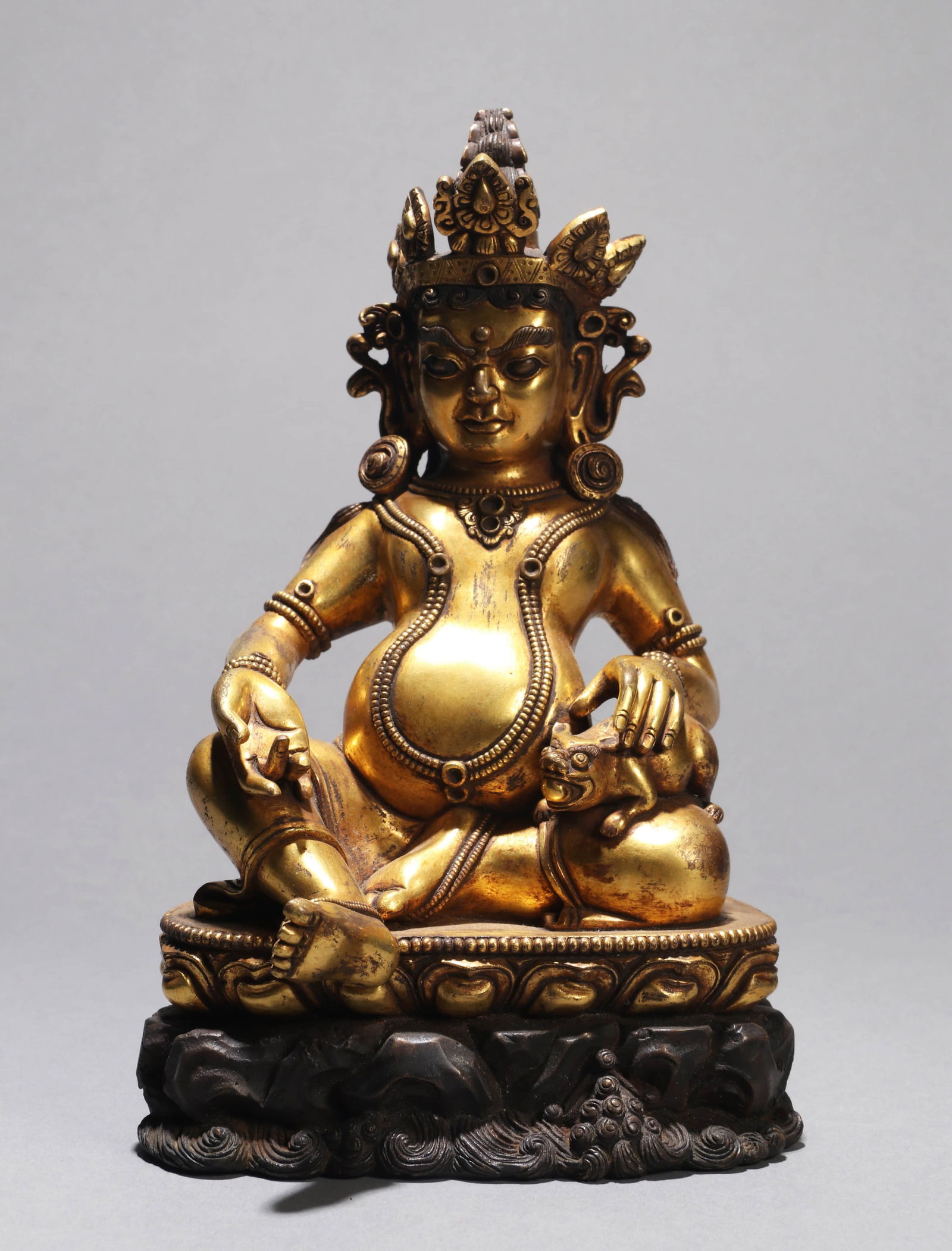 A GILT-BRONZE FIGURE OF JAMBHALAA