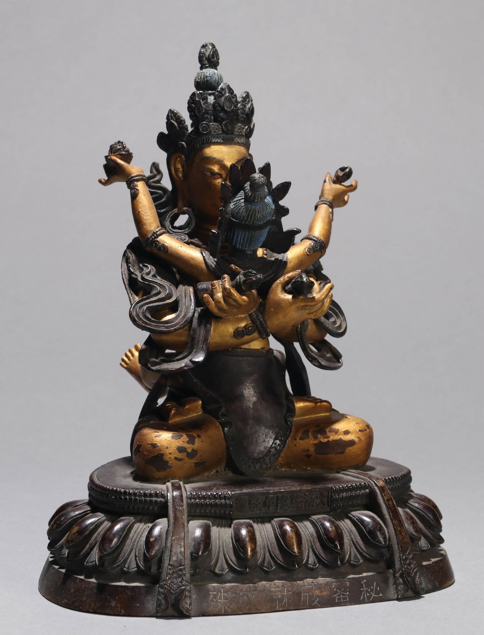 A GILT-BRONZE FIGURE OF