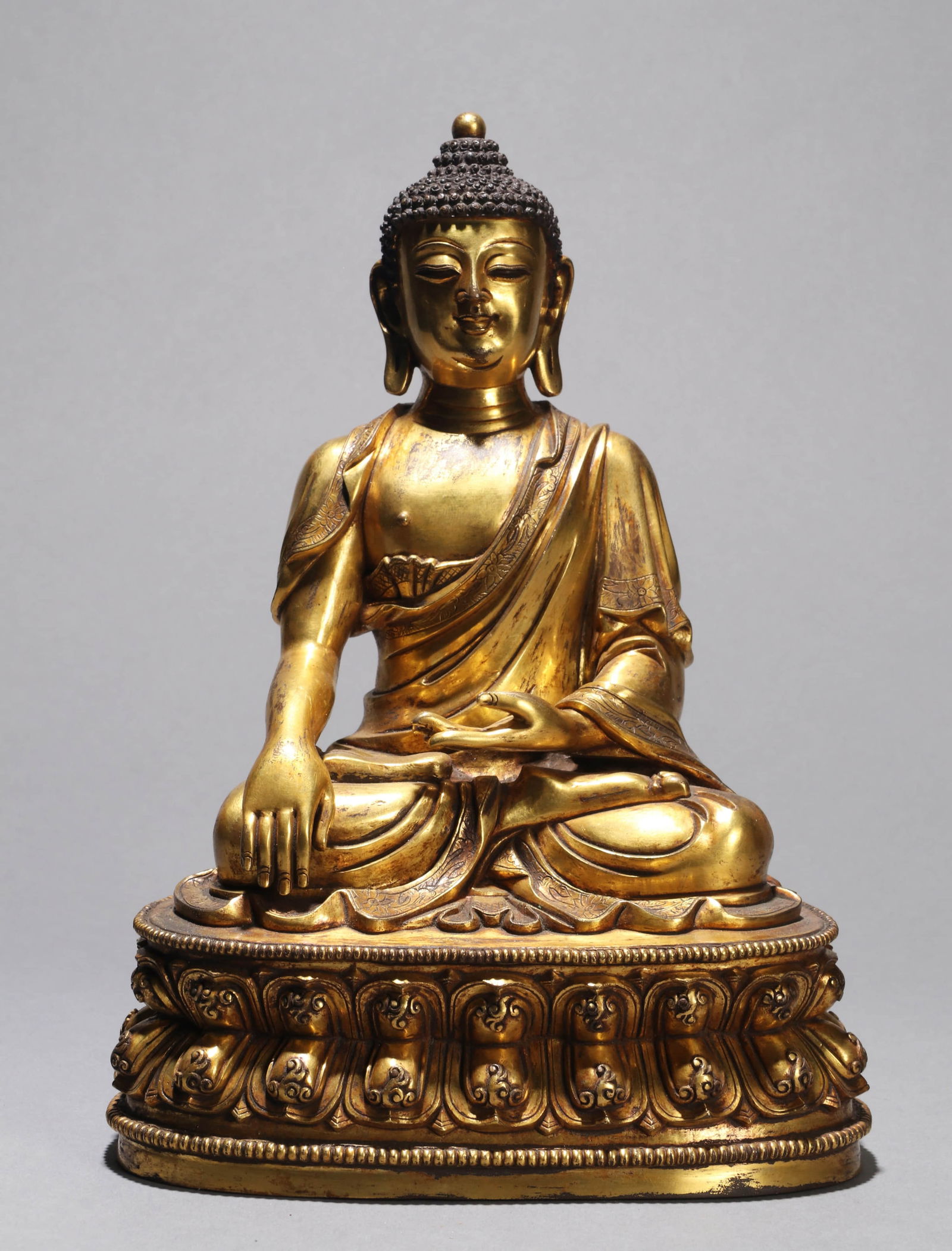 A  GILT-BRONZE FIGURE OF SHAKYAMUNI