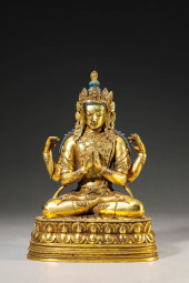A GILT-BRONZE FOUR-ARMED GUANY
