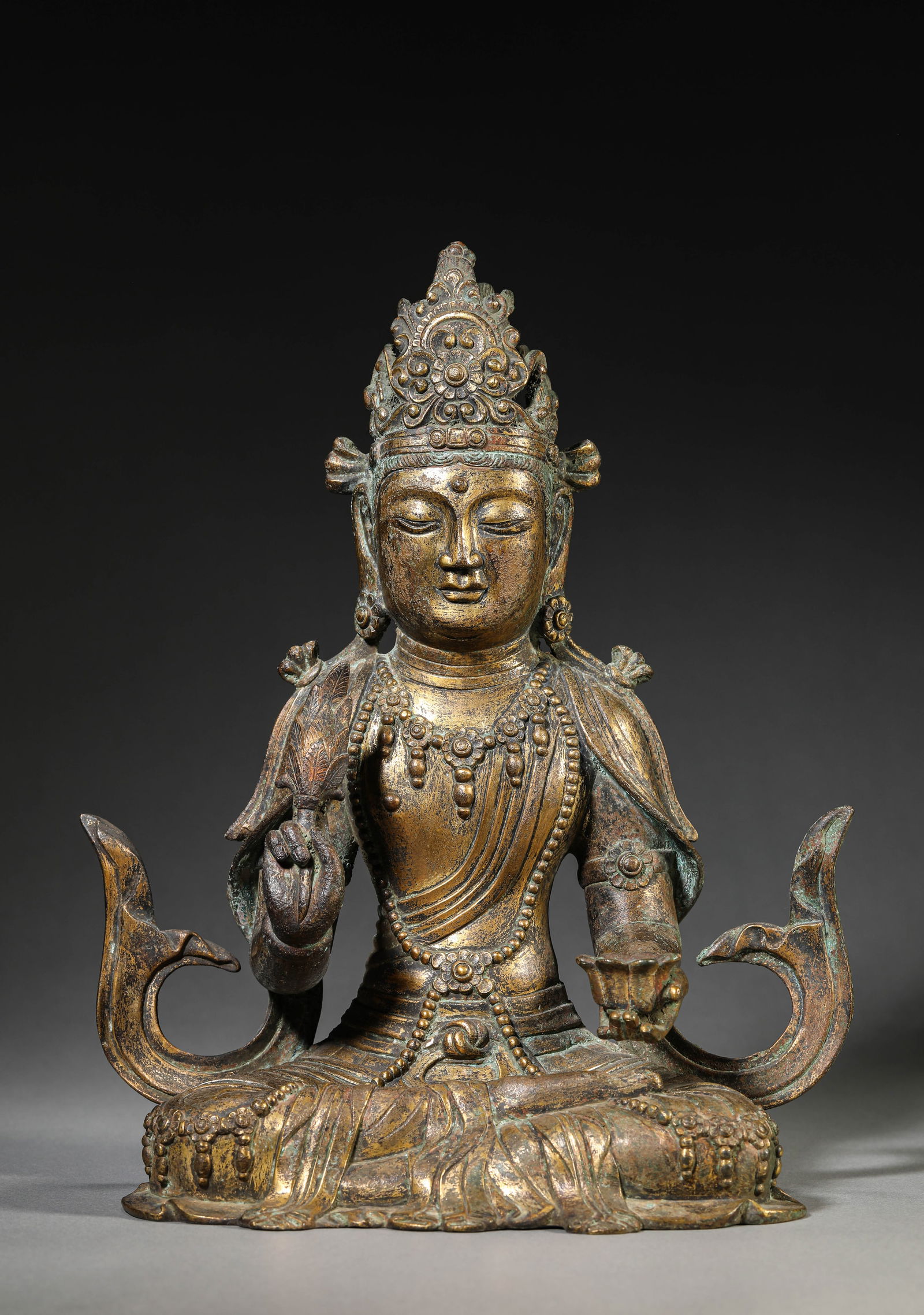 A GILT-BRONZE GUANYIN SEATED