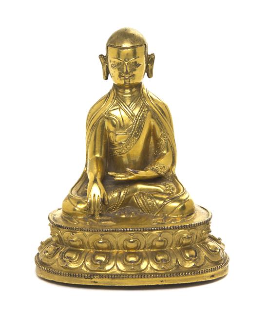 A Gilt Bronze Model of a Buddhist