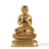 A GILT BRONZE SEATED FIGURE OF