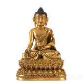 A GILT BRONZE SEATED FIGURE OF