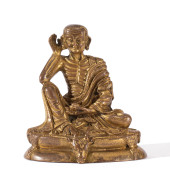 A GILT BRONZE SEATED FIGURE OF