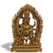 A GILT BRONZE STANDING FIGURE