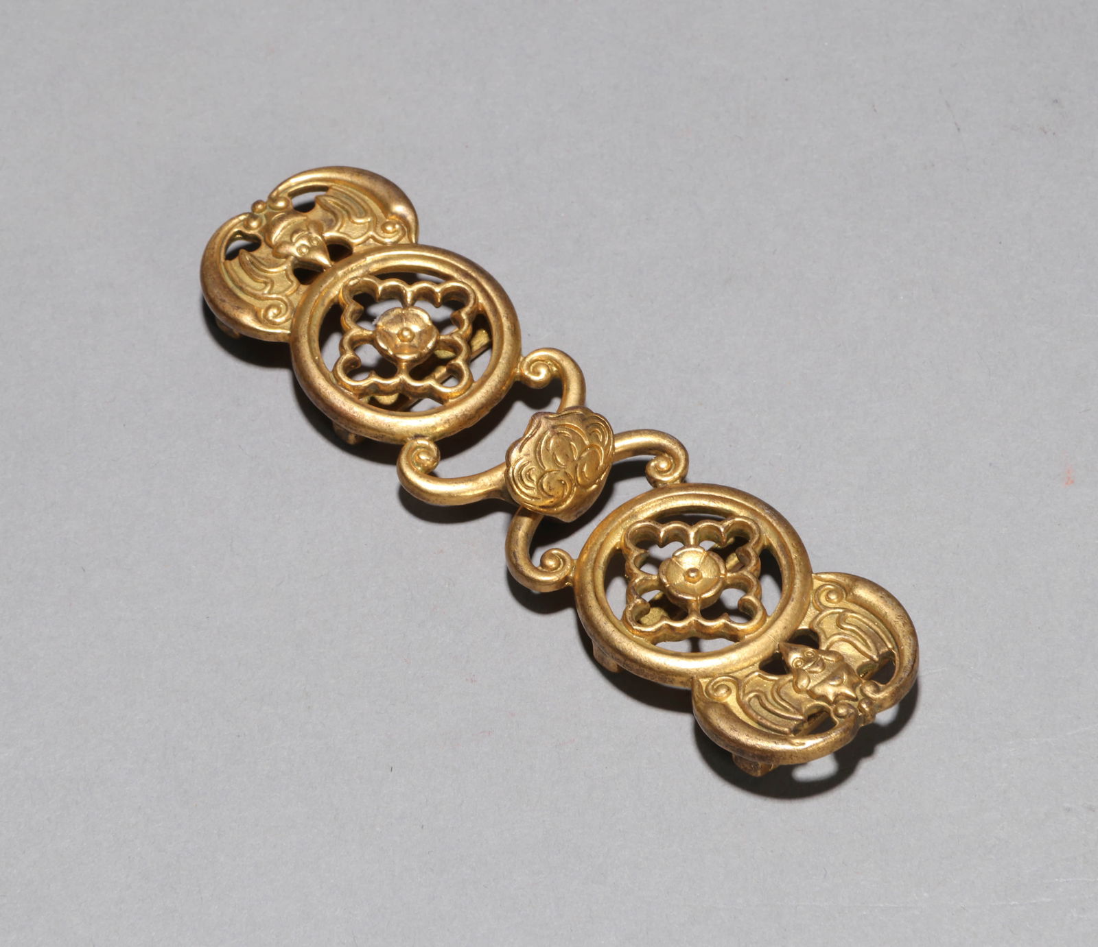 A GILT-COPPER BELTHOOKA GILT-COPPER