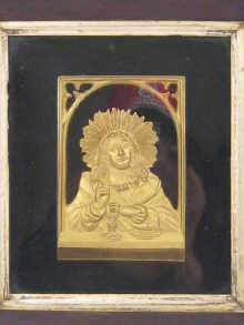A gilt metal devotional plaque in
