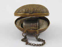 A gilt metal egg shaped thimble