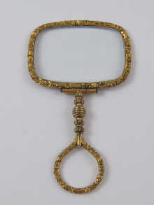 A gilt metal Regency quizzing glass