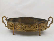 A gilt metal shaped oval