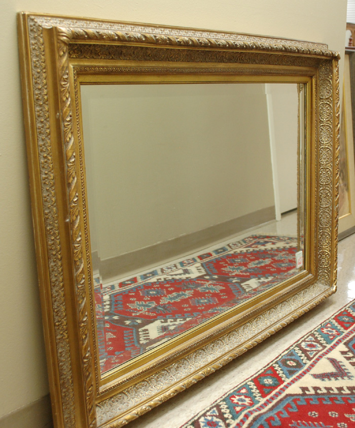 A GILT WOOD AND GESSO BEVELED