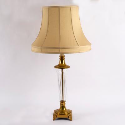 A glass and brass table lamp,