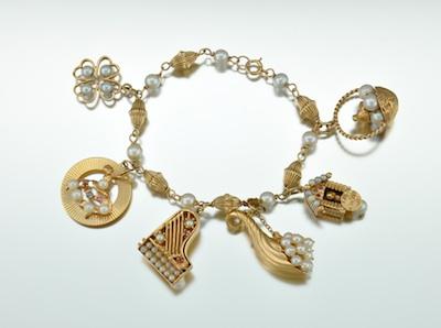 A Gold and Pearl Charm Bracelet 14k