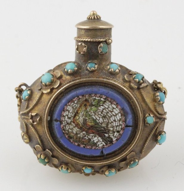 A gold coloured scent bottle