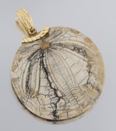 A Gold Mounted Fossilized Ston