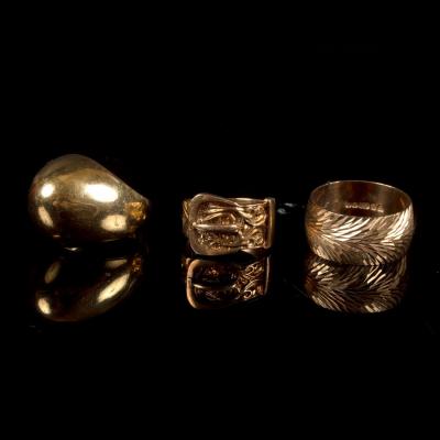 A gold ring of plain domed form,