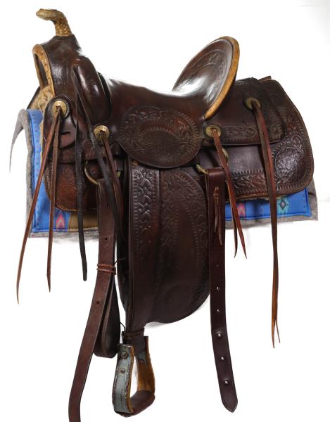 A GOOD HAND TOOLED HIGH BACK SADDLE