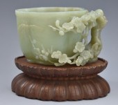 A GREEN HETIAN JADE "BLOSSOM"