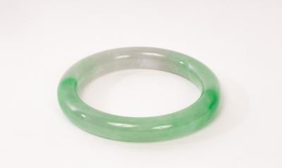 A green jadeite bangle, 20th