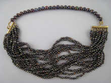 A grey cultured pearl necklace with