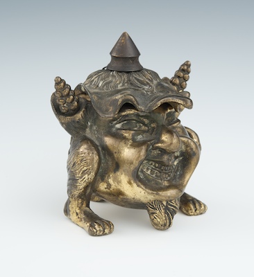 A Grotesque Figural Cigar Lighter