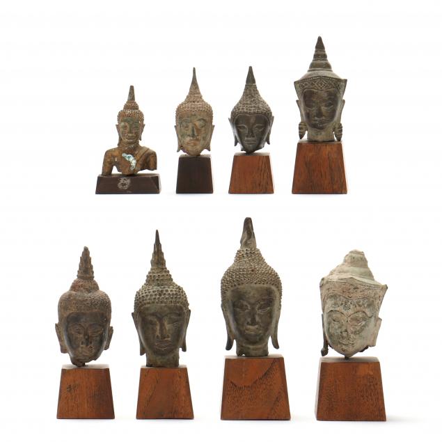 A GROUP OF BRONZE BUDDHA HEADS FROM