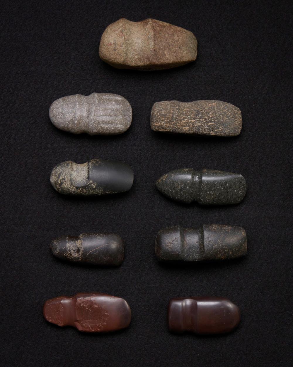 A GROUP OF CARVED STONE GROOVED