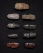 A GROUP OF CARVED STONE GROOVE