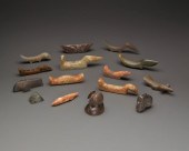 A GROUP OF CARVED STONE IMPLEM