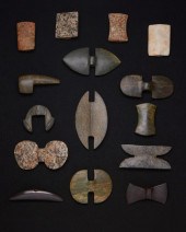 A GROUP OF CARVED STONE ATLATL