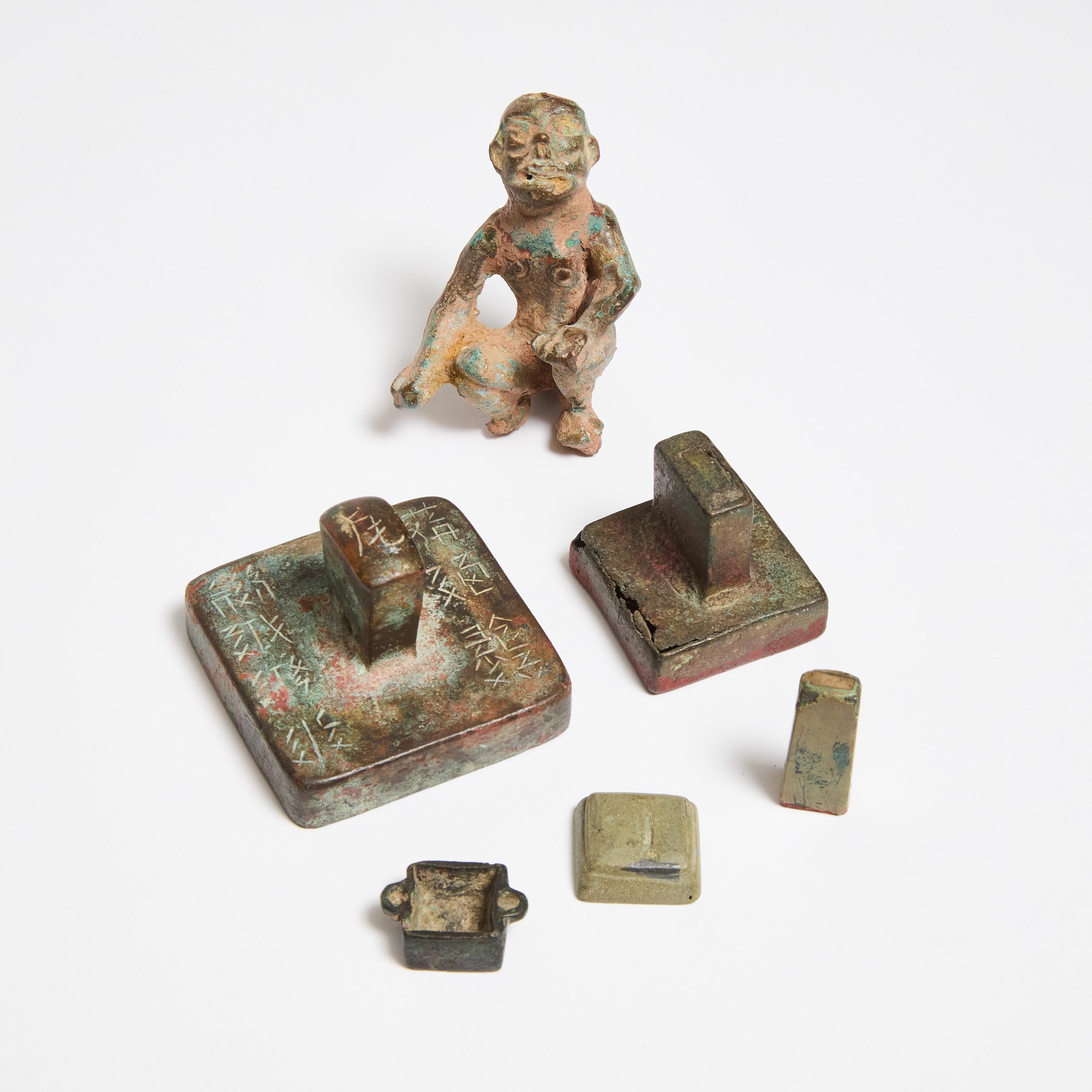 A Group of Five Bronze and Stone