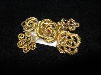 A group of five gold pins   
