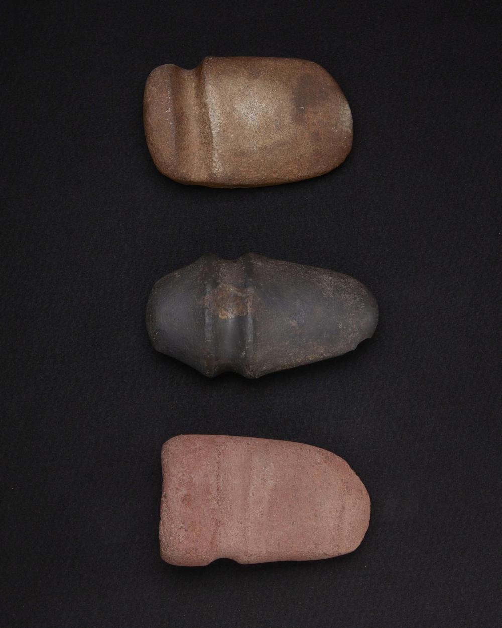 A GROUP OF LARGE CARVED STONE AXESA