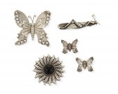 A GROUP OF SILVER BROOCHES BY