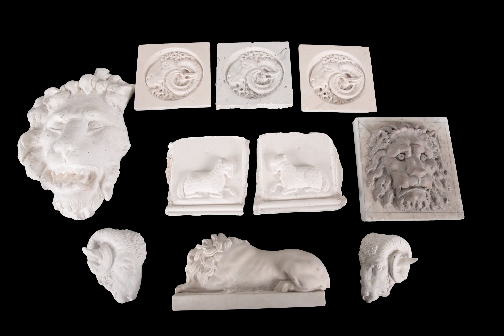 A GROUP OF TEN PLASTER RELIEFS of