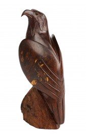 A hand carved wood eagle on pe