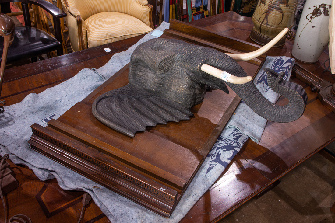 A HAND CARVED WOOD ELEPHANT HEAD,