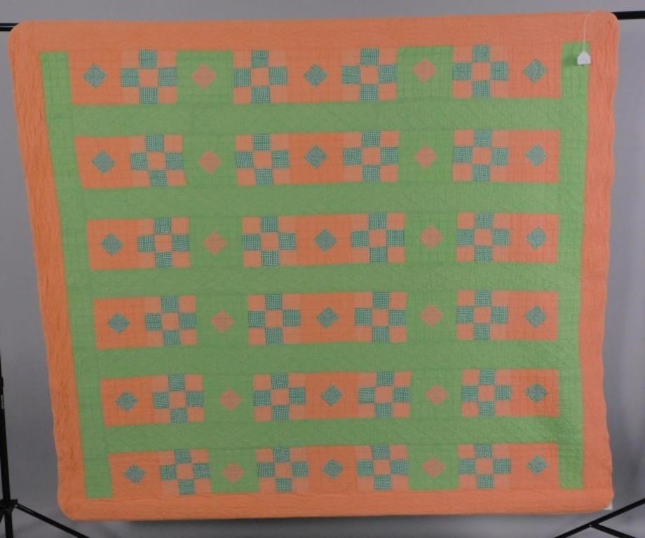 A HAND SEWN QUILT COMPOSED OF