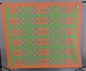 A HAND SEWN QUILT COMPOSED OF