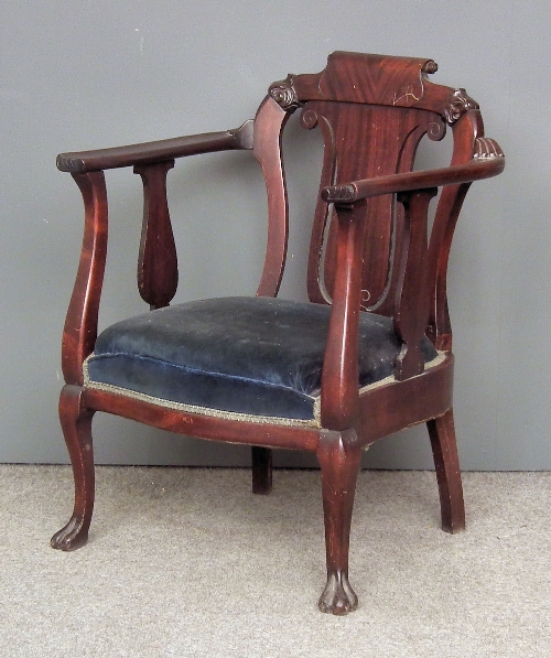 A hardwood tub shaped armchair of